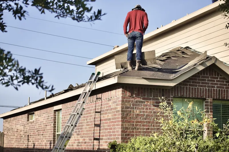 Professional roofer working on a residential roof in Burkittsville